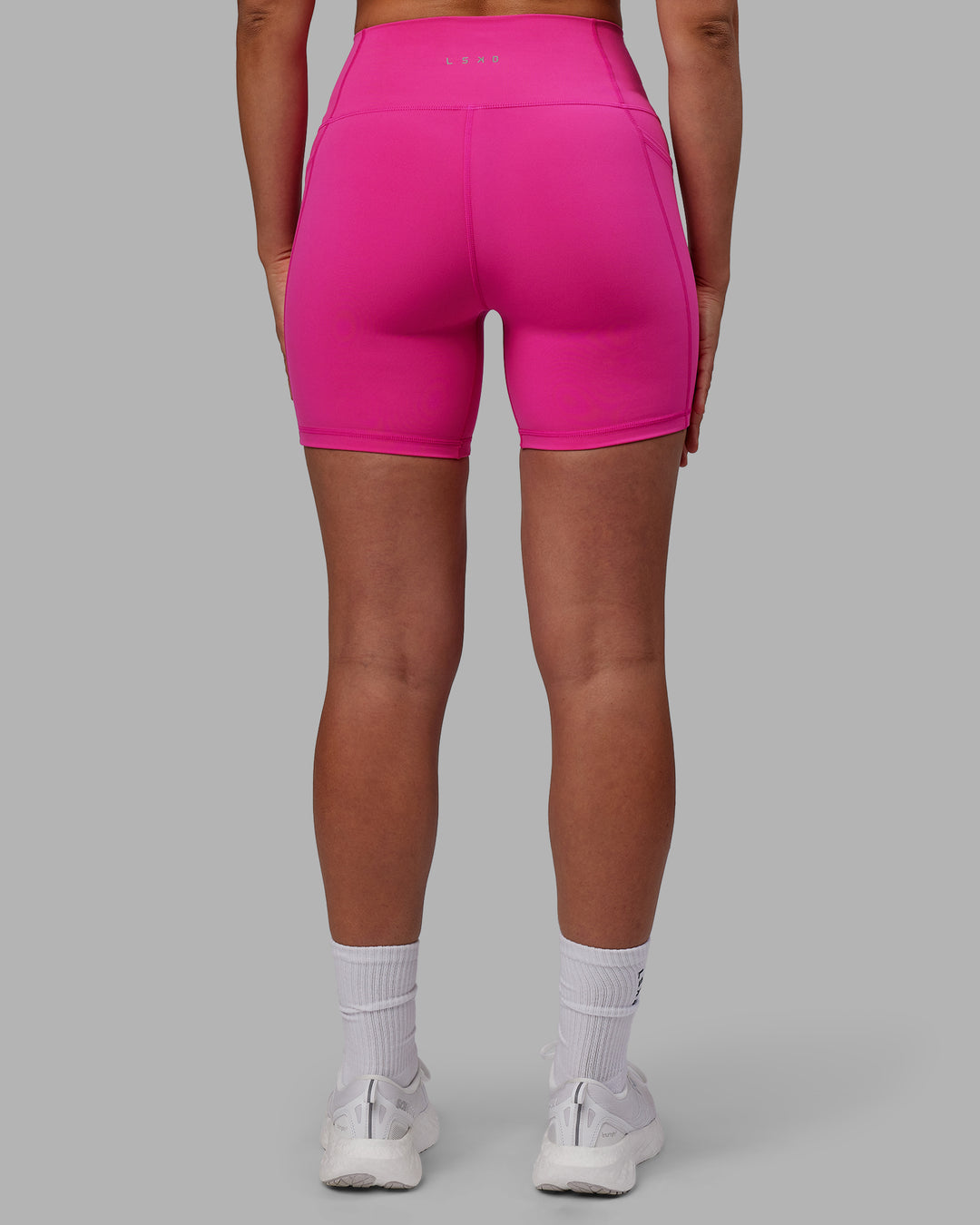 Woman wearing Fusion Ultra High-Rise 6" Short Pockets - Fuchsia Pink | Set:true | Angle:back | Model:Sophie | Size:S - view 3