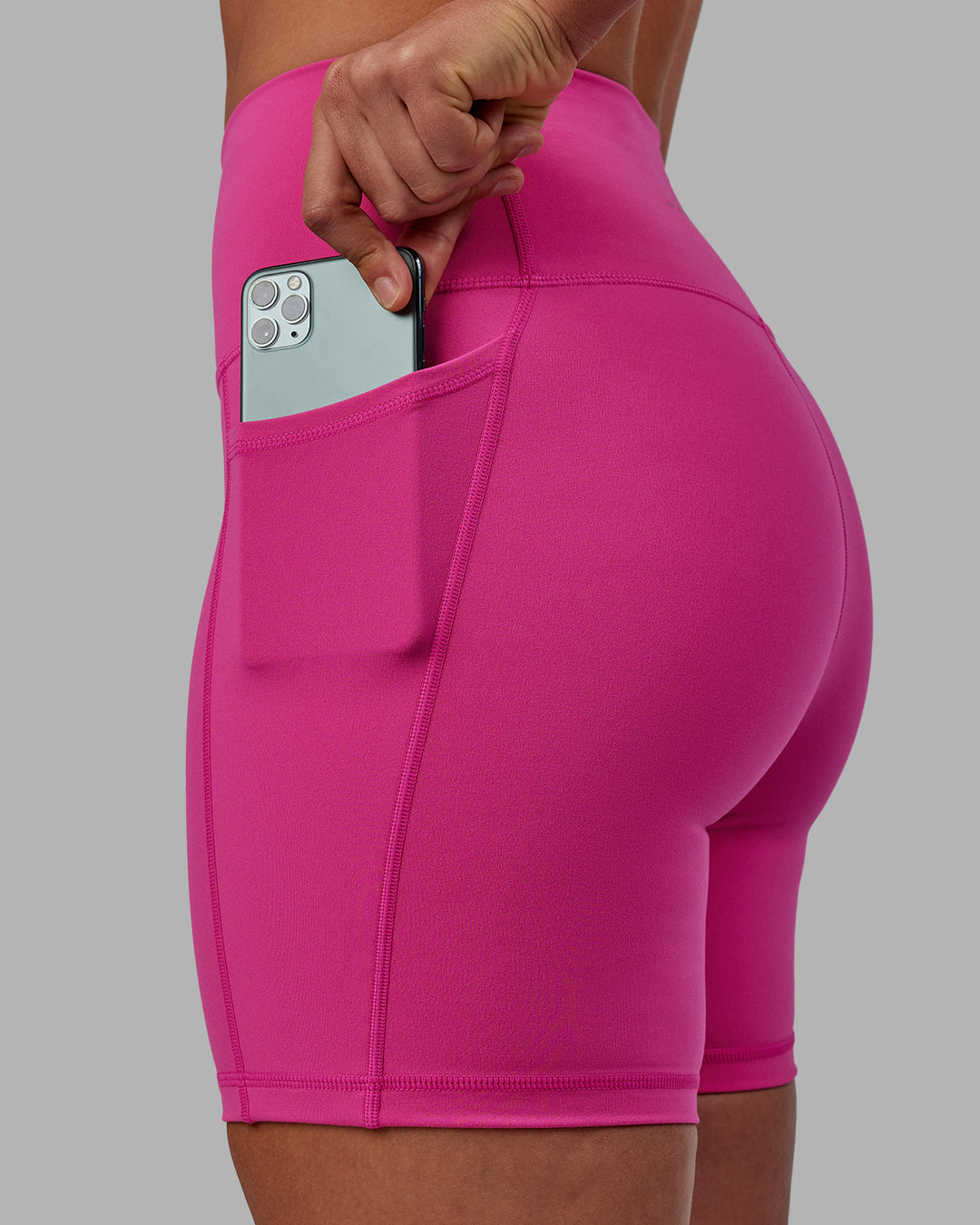 Woman wearing Fusion Ultra High-Rise 6" Short Pockets - Fuchsia Pink | Set:true | Angle:closeup | Model:Sophie | Size:S - view 4