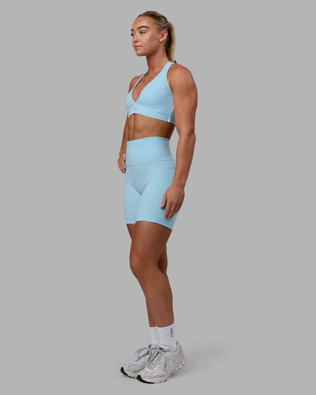 Woman wearing Fusion Ultra High-Rise 6" Short Pockets - Glacial Blue | Model:Monique | Size:S - view 7