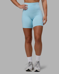 Woman wearing Fusion Ultra High-Rise 6" Short Pockets - Glacial Blue | Model:Monique | Size:S | Thumbnail Index: 0
