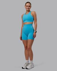 Woman wearing Fusion Ultra High-Rise 6" Short Pockets - Pacific Blue | Model:Lillie | Size:S | Thumbnail Index: 1