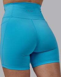 Woman wearing Fusion Ultra High-Rise 6" Short Pockets - Pacific Blue | Model:Lillie | Size:S | Thumbnail Index: 5