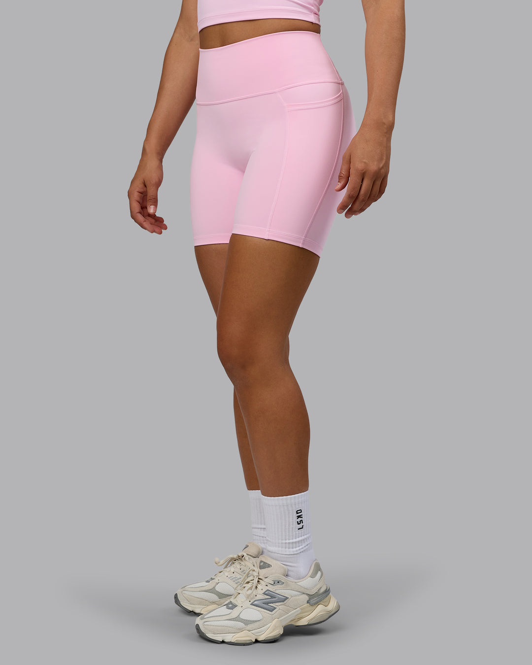 Woman wearing Fusion Ultra High-Rise 6" Short Pockets - Pale Pink | Model:Sophie | Size:S - view 1