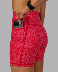 Woman wearing Fusion Ultra High-Rise 6" Short Pockets - Red Vitality Print | Model:Halle | Size:S | Thumbnail Index: 5