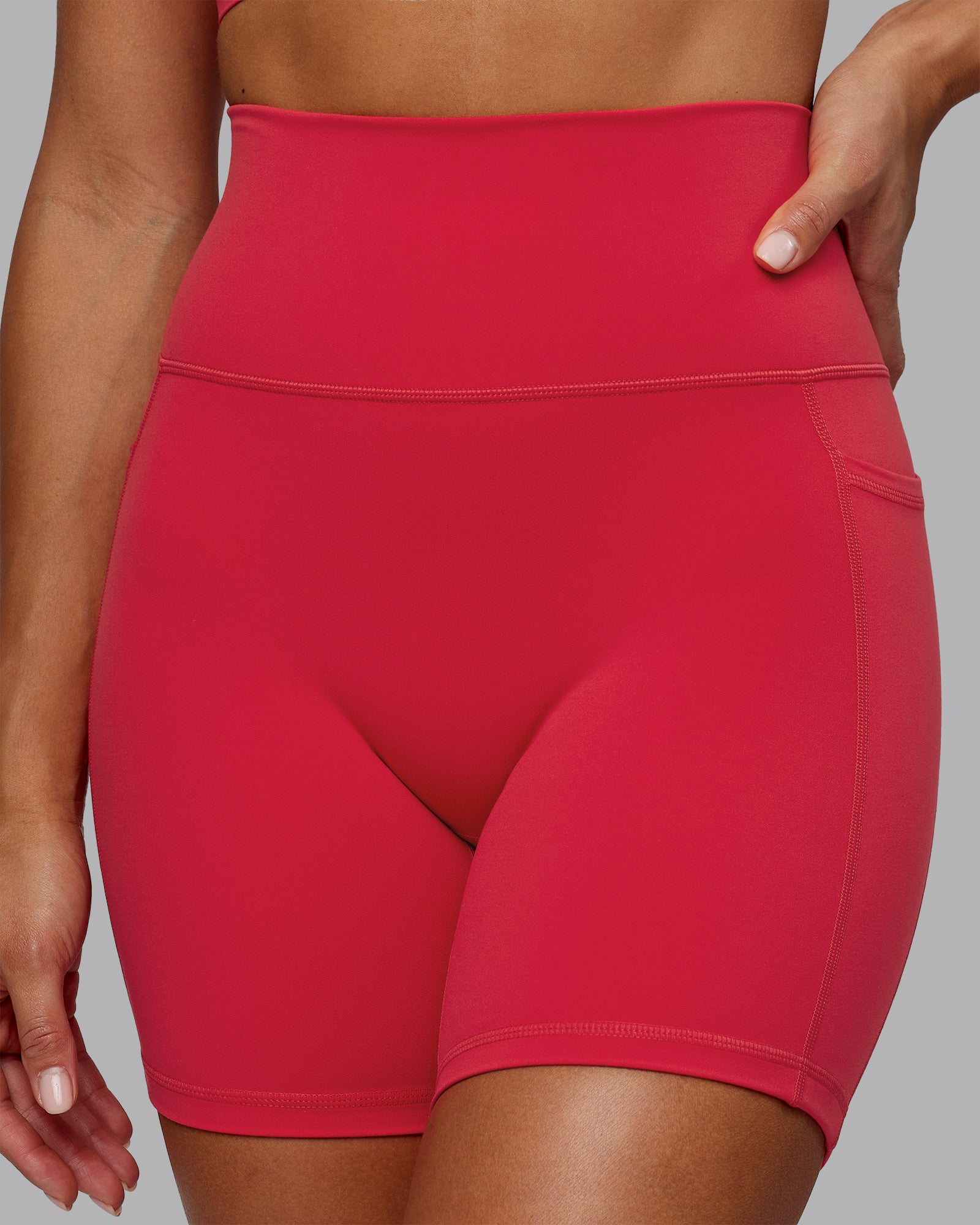 Woman wearing Fusion Ultra High-Rise 6" Short Pockets - Scarlet | Model:Demi | Size:S