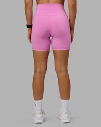 Woman wearing Fusion Ultra High-Rise 6" Short Pockets - Spark Pink | Model:Halle | Size:S | Thumbnail Index: 2