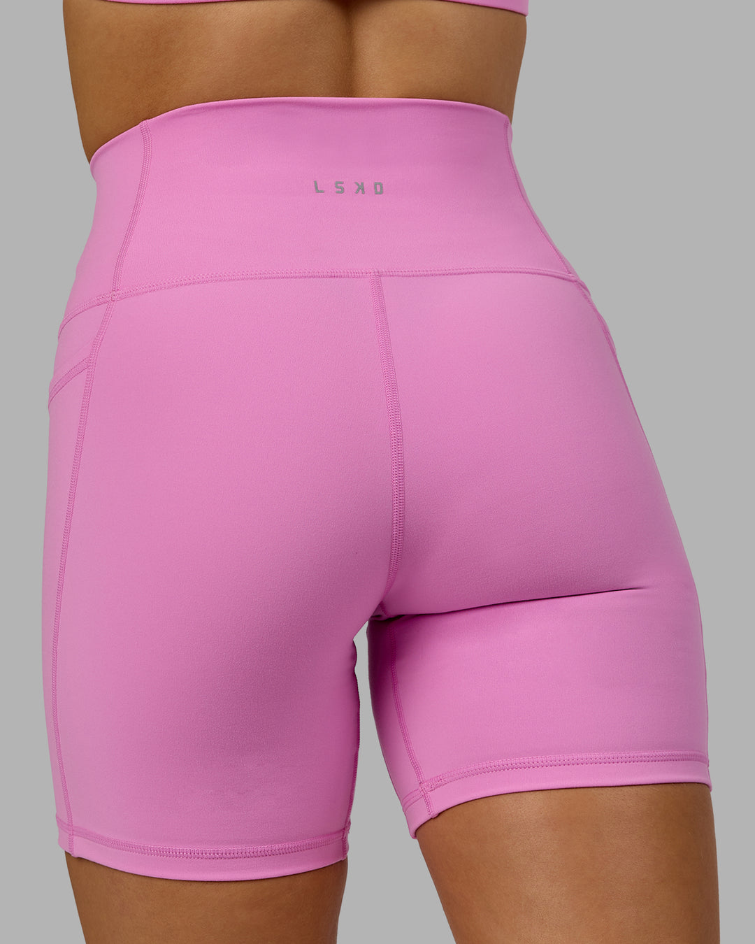 Woman wearing Fusion Ultra High-Rise 6" Short Pockets - Spark Pink | Model:Halle | Size:S - view 7