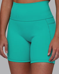 Woman wearing Fusion Ultra High-Rise 6" Short Pockets - Turquoise Tide | Model:Hannah | Size:S | Thumbnail Index: 0