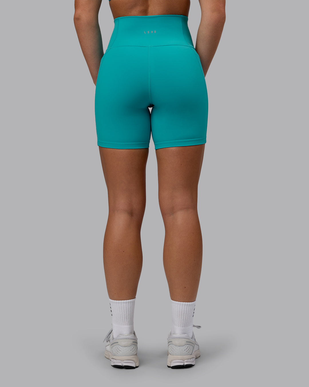Woman wearing Fusion Ultra High-Rise 6" Short Pockets - Uplift Blue | Set:true | Angle:back | Model:Monique | Size:S - view 3