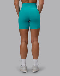Woman wearing Fusion Ultra High-Rise 6" Short Pockets - Uplift Blue | Set:true | Angle:back | Model:Monique | Size:S | Thumbnail Index: 2