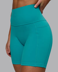 Woman wearing Fusion Ultra High-Rise 6" Short Pockets - Uplift Blue | Model:Monique | Size:S | Thumbnail Index: 0