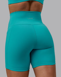 Woman wearing Fusion Ultra High-Rise 6" Short Pockets - Uplift Blue | Model:Monique | Size:S | Thumbnail Index: 7