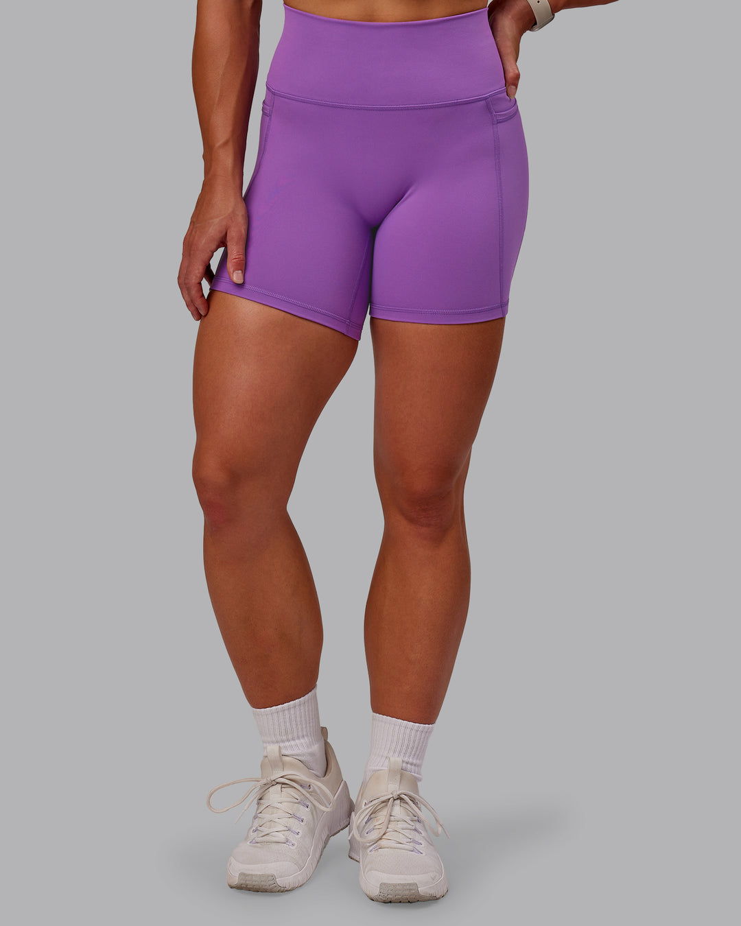 Woman wearing Fusion Ultra High-Rise 6" Short Pockets - Purple Fizz | Set:true | Angle:front | Model:Amber | Size:S - view 7