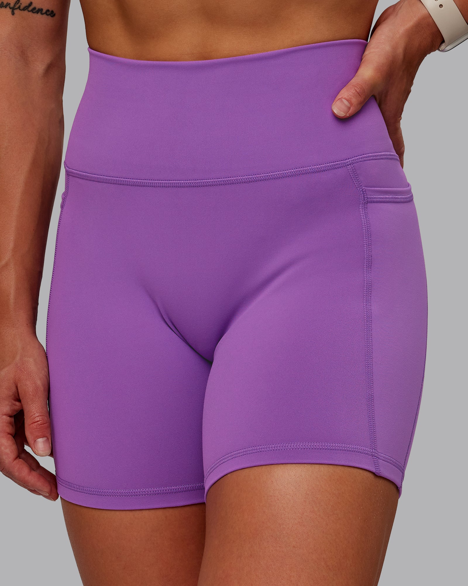 Woman wearing Fusion Ultra High-Rise 6" Short Pockets - Purple Fizz | Model:Amber | Size:S