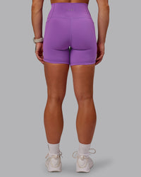 Woman wearing Fusion Ultra High-Rise 6" Short Pockets - Purple Fizz | Set:true | Angle:back | Model:Amber | Size:S | Thumbnail Index: 3