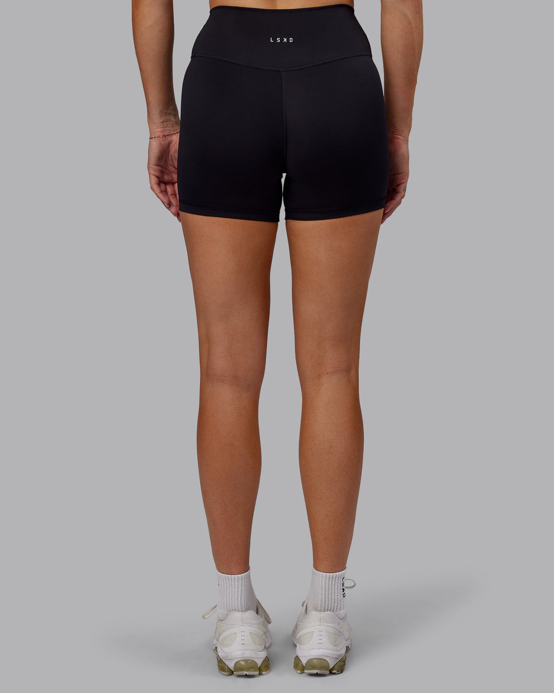 Woman wearing Fusion Ultra High-Rise 4" Short - Black | Set:true | Angle:back | Model:Hannah | Size:S - view 4