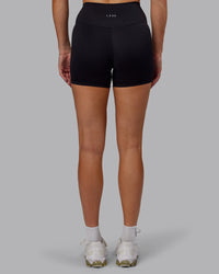 Woman wearing Fusion Ultra High-Rise 4" Short - Black | Set:true | Angle:back | Model:Hannah | Size:S | Thumbnail Index: 3