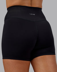 Woman wearing Fusion Ultra High-Rise 4" Short - Black | Model:Hannah | Size:S | Thumbnail Index: 6