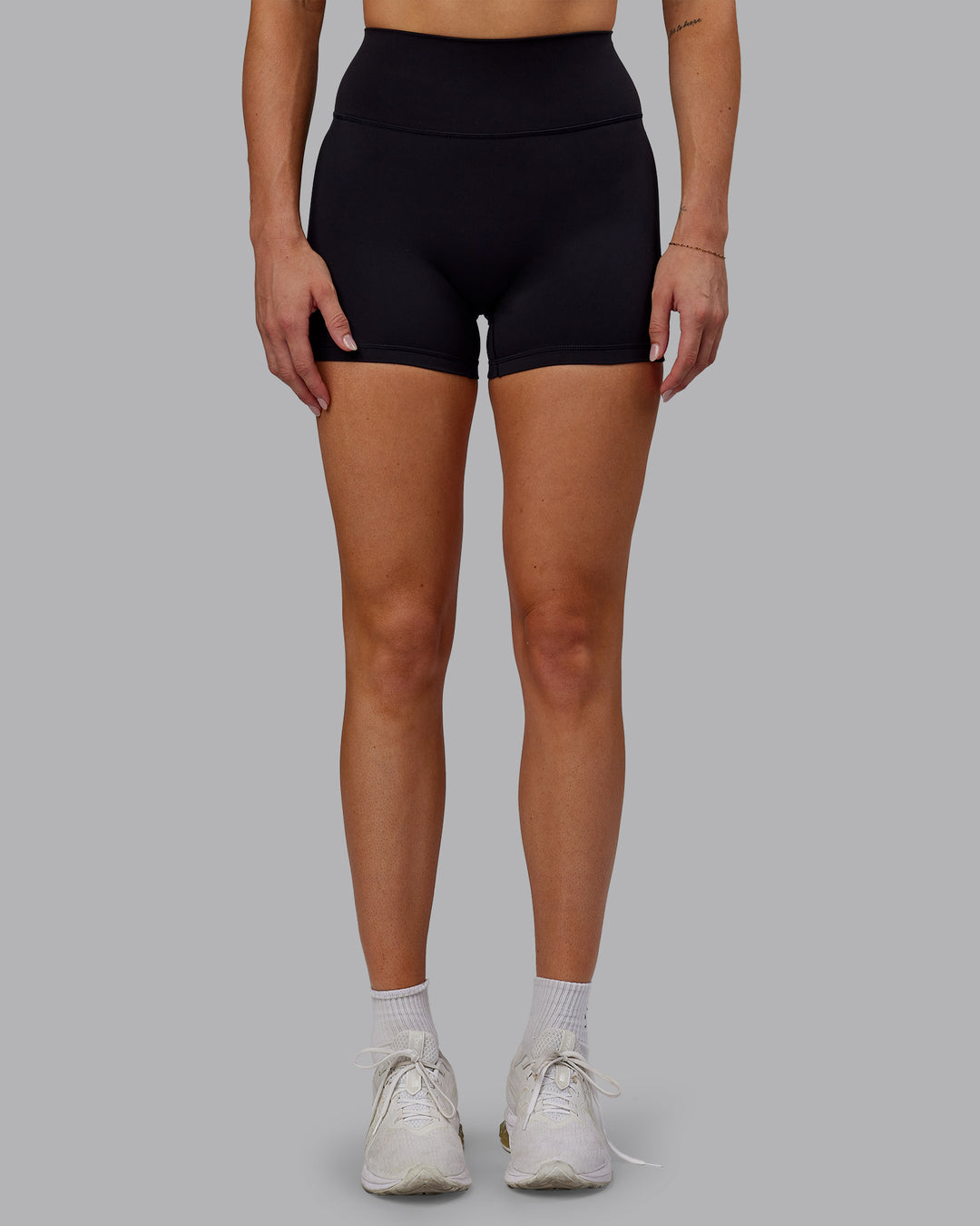 Woman wearing Fusion Ultra High-Rise 4" Short - Black | Set:true | Angle:front | Model:Hannah | Size:S - view 5