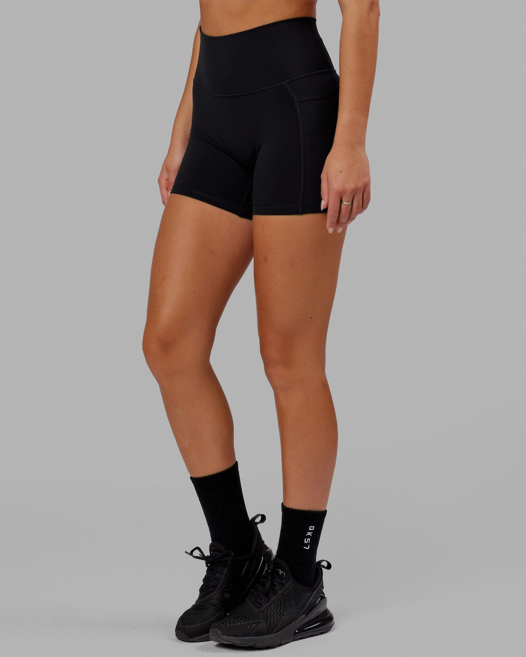 Woman wearing O.G. Fusion Ultra High-Rise 4" Short Pockets - Black | Model:Milly | Size:S - view 8