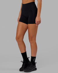 Woman wearing O.G. Fusion Ultra High-Rise 4" Short Pockets - Black | Model:Milly | Size:S | Thumbnail Index: 7