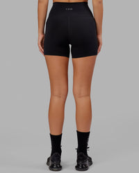 Woman wearing O.G. Fusion Ultra High-Rise 4" Short Pockets - Black | Model:Milly | Size:S | Thumbnail Index: 2