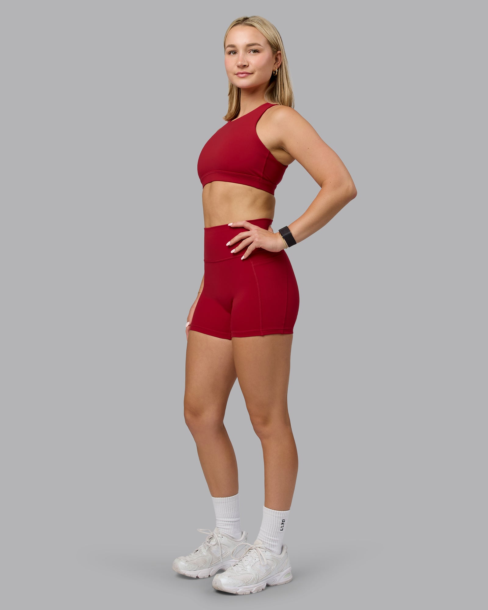 Woman wearing Fusion Ultra High-Rise 4" Short Pockets - Cherry Red | Model:Halle | Size:S