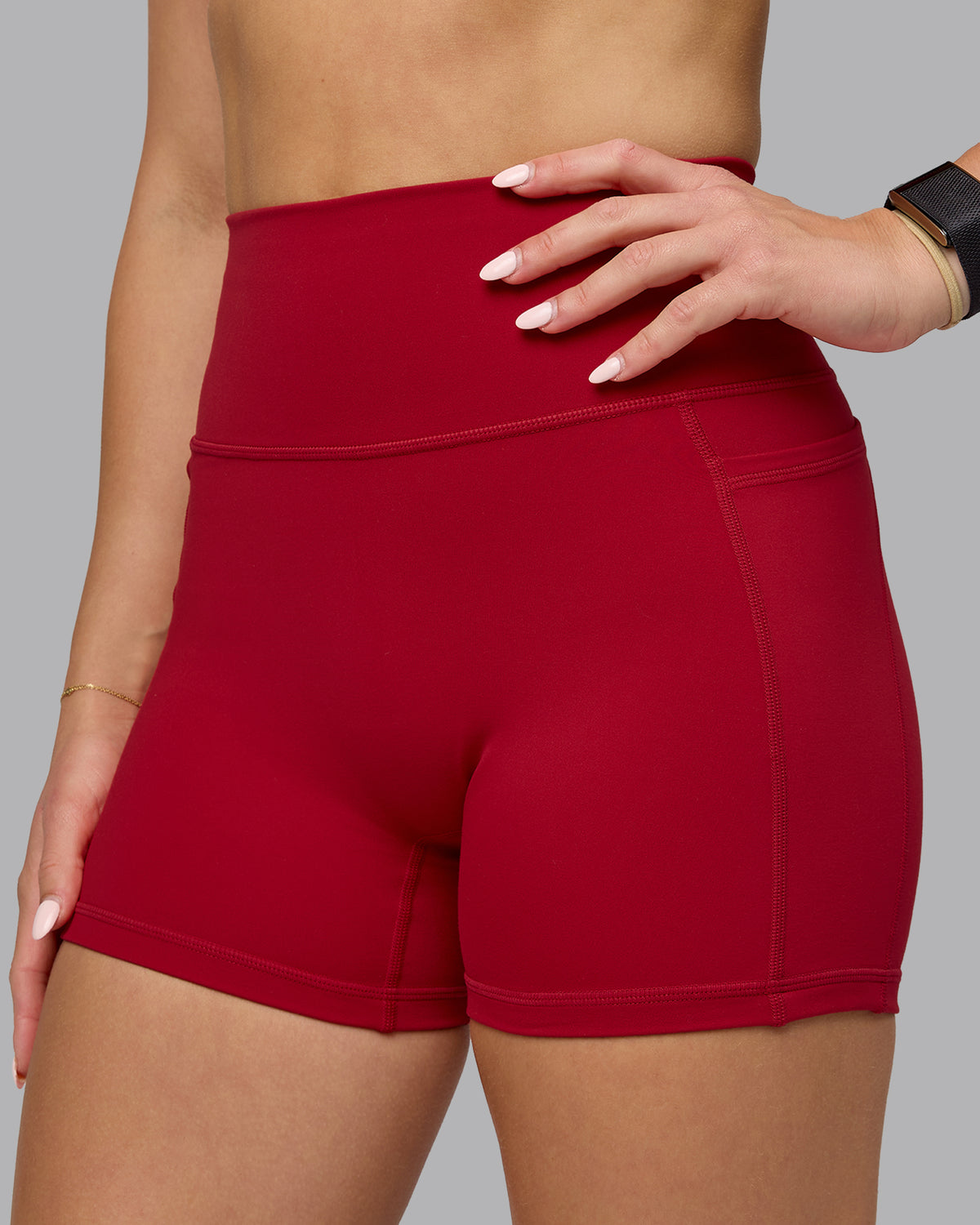 Woman wearing Fusion Ultra High-Rise 4" Short Pockets - Cherry Red | Model:Halle | Size:S