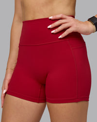 Woman wearing Fusion Ultra High-Rise 4" Short Pockets - Cherry Red | Model:Halle | Size:S | Thumbnail Index: 0