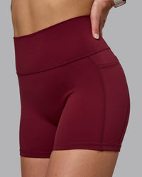 Woman wearing Fusion Ultra High-Rise 4" Short Pockets - Cordovan | Model:Chloe | Size:XS | Thumbnail Index: 0