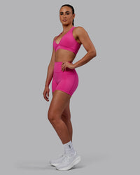 Woman wearing Fusion Ultra High-Rise 4" Short Pockets - Fuchsia Pink | Model:Sophie | Size:S | Thumbnail Index: 4