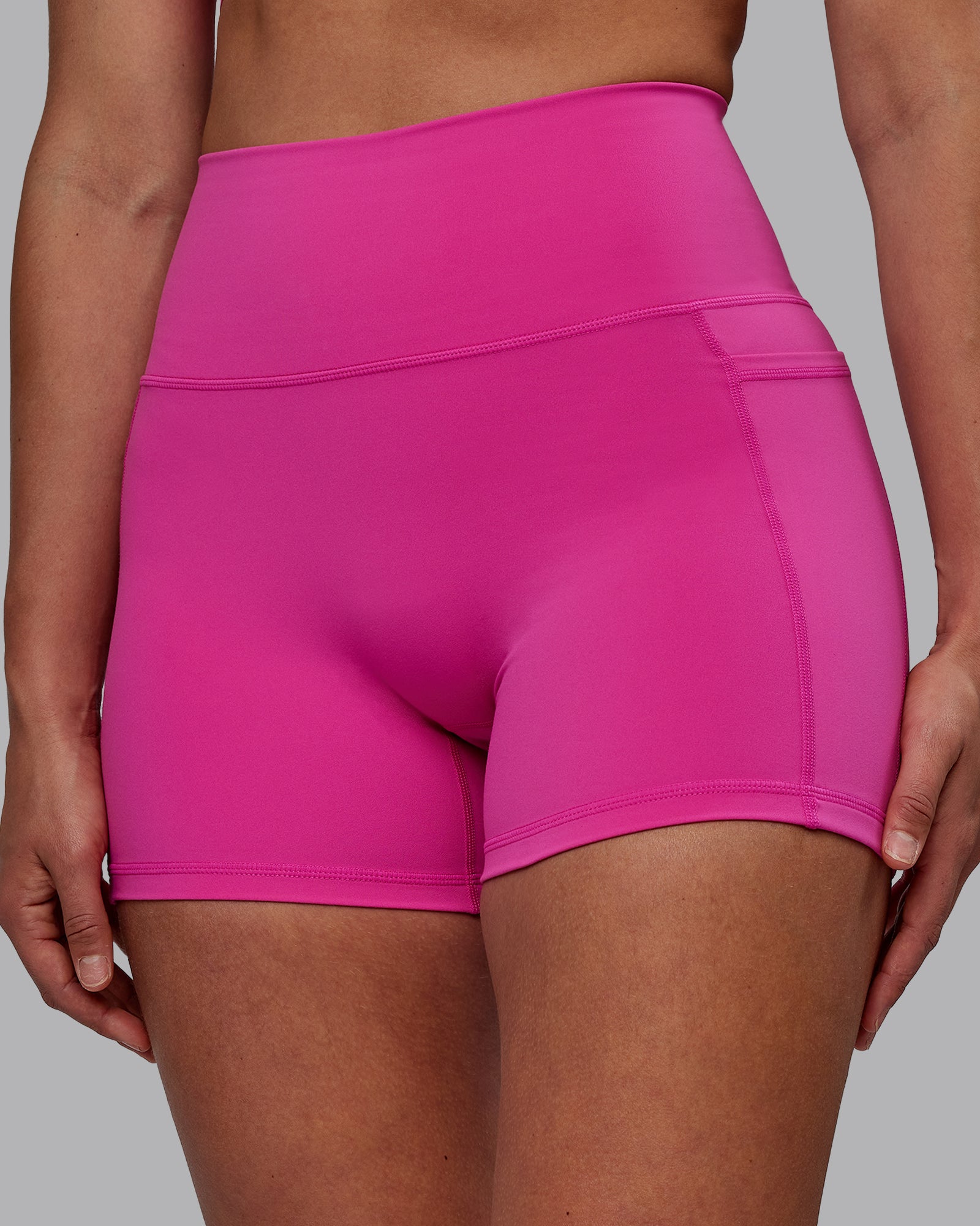 Woman wearing Fusion Ultra High-Rise 4" Short Pockets - Fuchsia Pink | Model:Sophie | Size:S