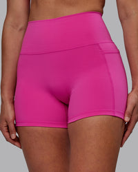 Woman wearing Fusion Ultra High-Rise 4" Short Pockets - Fuchsia Pink | Model:Sophie | Size:S | Thumbnail Index: 0