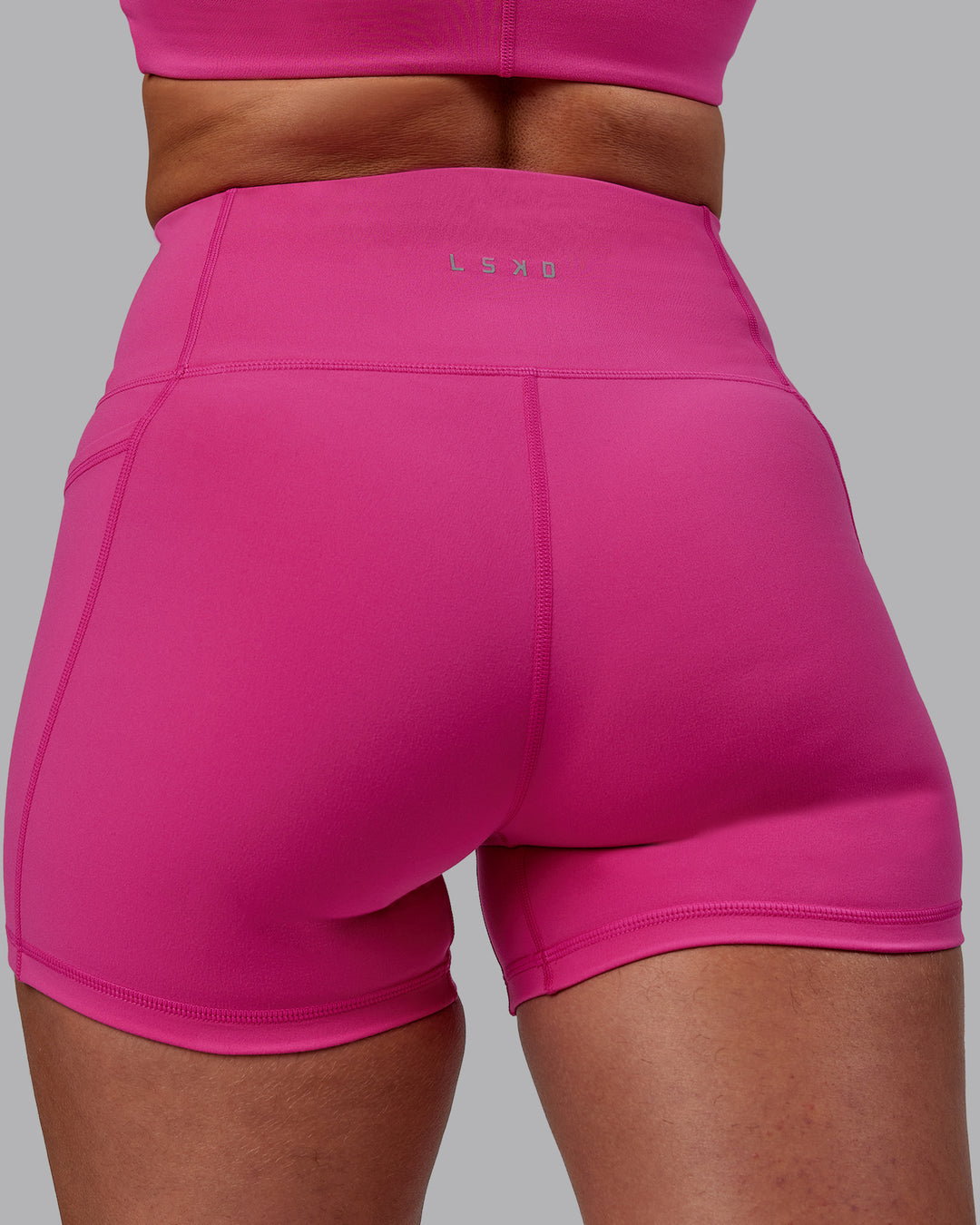 Woman wearing Fusion Ultra High-Rise 4" Short Pockets - Fuchsia Pink | Model:Sophie | Size:S - view 7