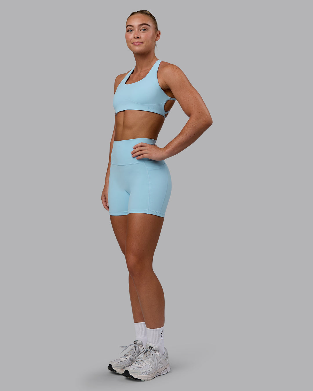 Woman wearing Fusion Ultra High-Rise 4" Short Pockets - Glacial Blue | Model:Monique | Size:S - view 4