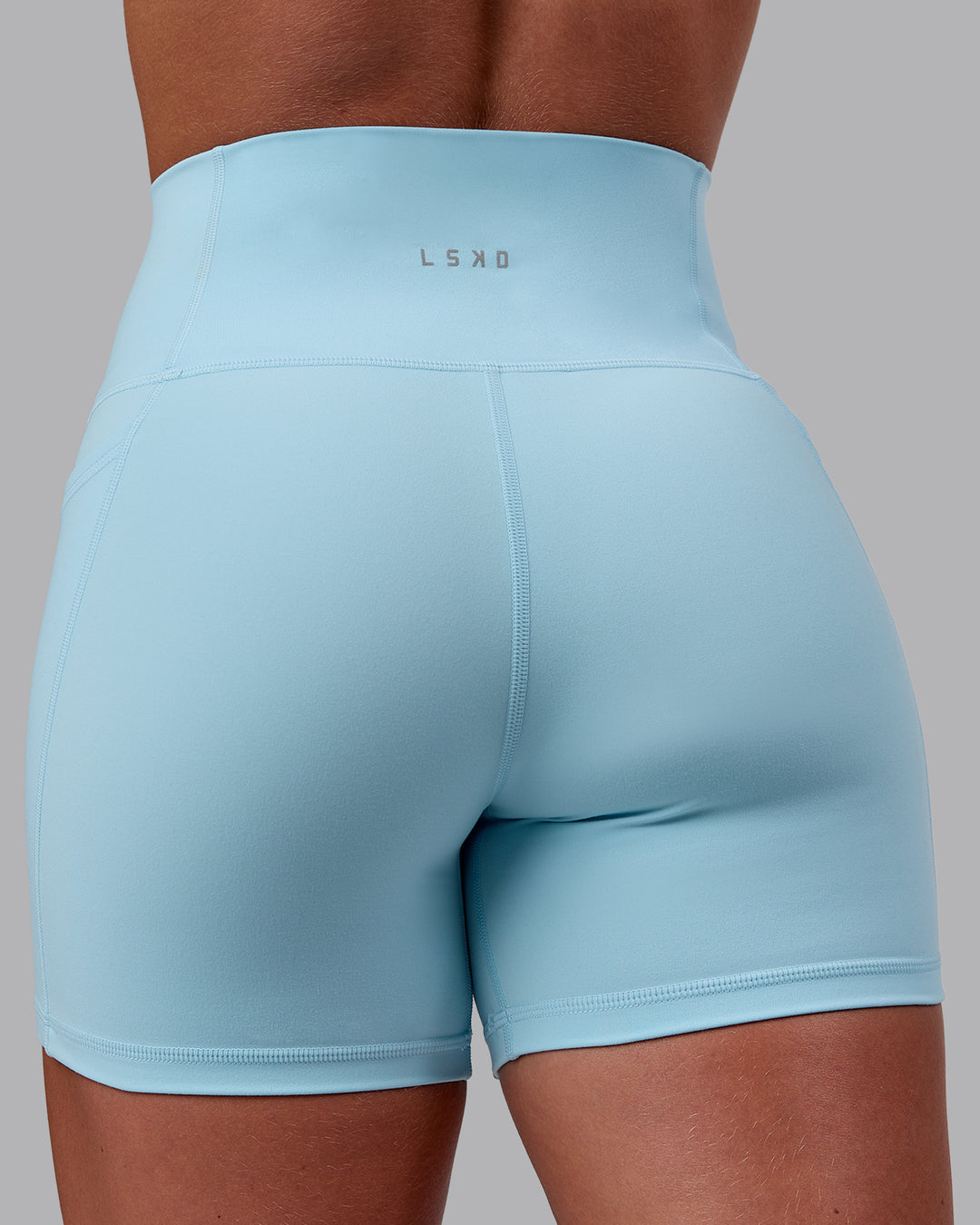 Woman wearing Fusion Ultra High-Rise 4" Short Pockets - Glacial Blue | Model:Monique | Size:S - view 9