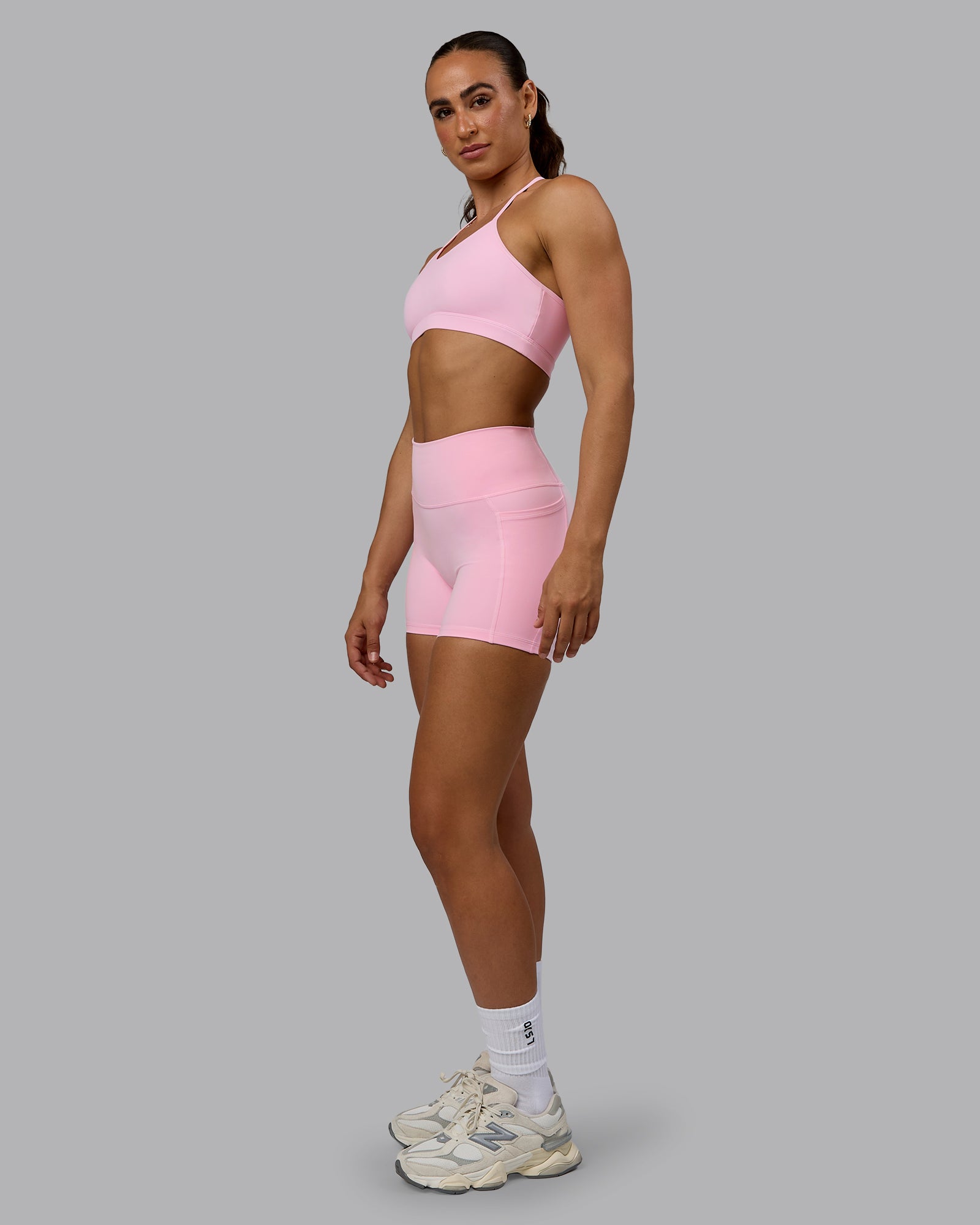 Woman wearing Fusion Ultra High-Rise 4" Short Pockets - Pale Pink | Model:Sophie | Size:S