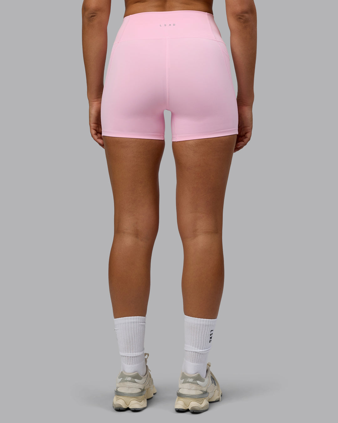 Woman wearing Fusion Ultra High-Rise 4" Short Pockets - Pale Pink | Model:Sophie | Size:S - view 3