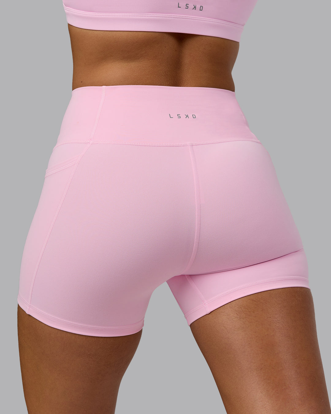 Woman wearing Fusion Ultra High-Rise 4" Short Pockets - Pale Pink | Model:Sophie | Size:S - view 8