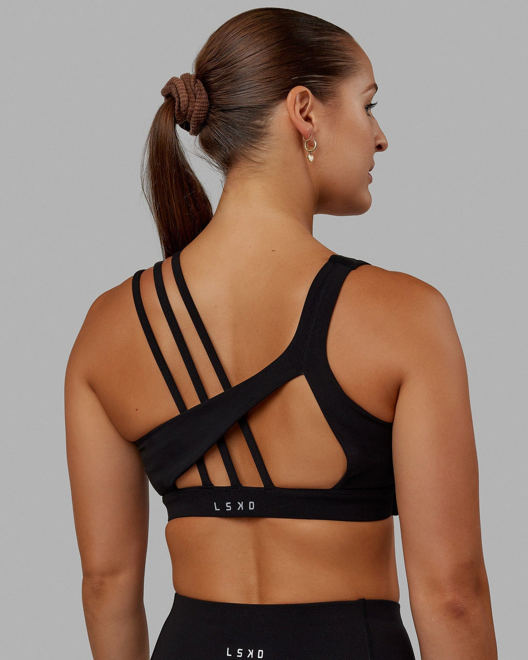 Woman wearing Galvanise Sports Bra - Black - view 1