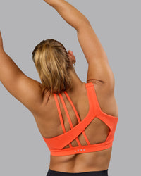Woman wearing Galvanise Sports Bra - Ultra Orange | Thumbnail Index: 4