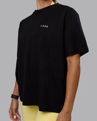 Woman wearing Go-To We Rise FLXCotton Oversized Tee - Black-Glacial Blue | Thumbnail Index: 3