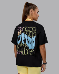 Woman wearing Go-To We Rise FLXCotton Oversized Tee - Black-Glacial Blue | Thumbnail Index: 4
