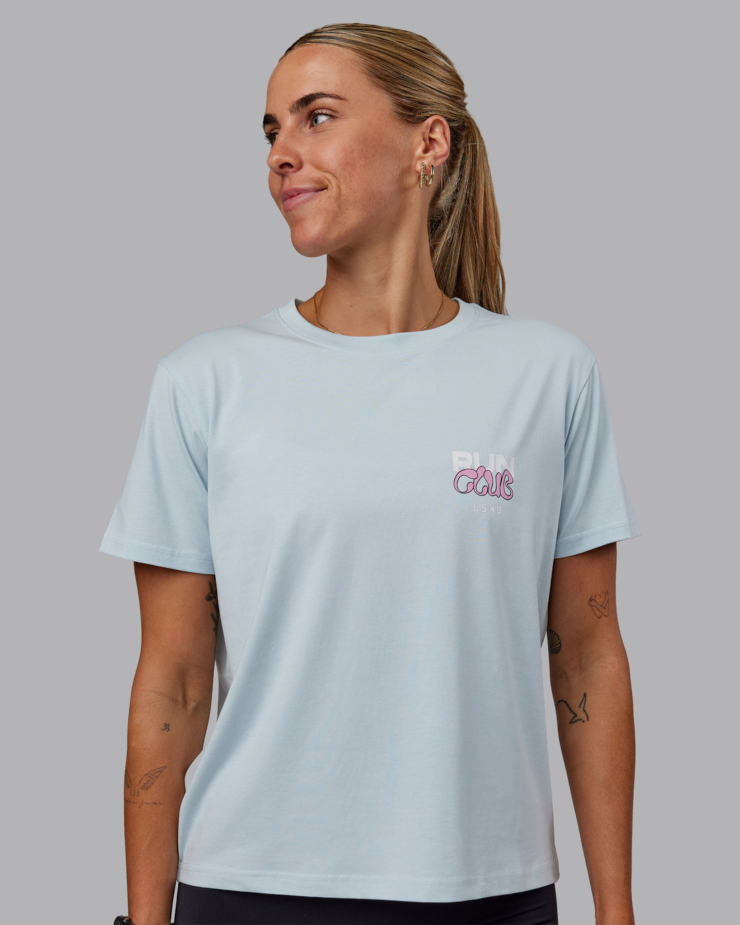 Woman wearing Gone Running FLXCotton Tee - Skyride-Bubblegum - view 1