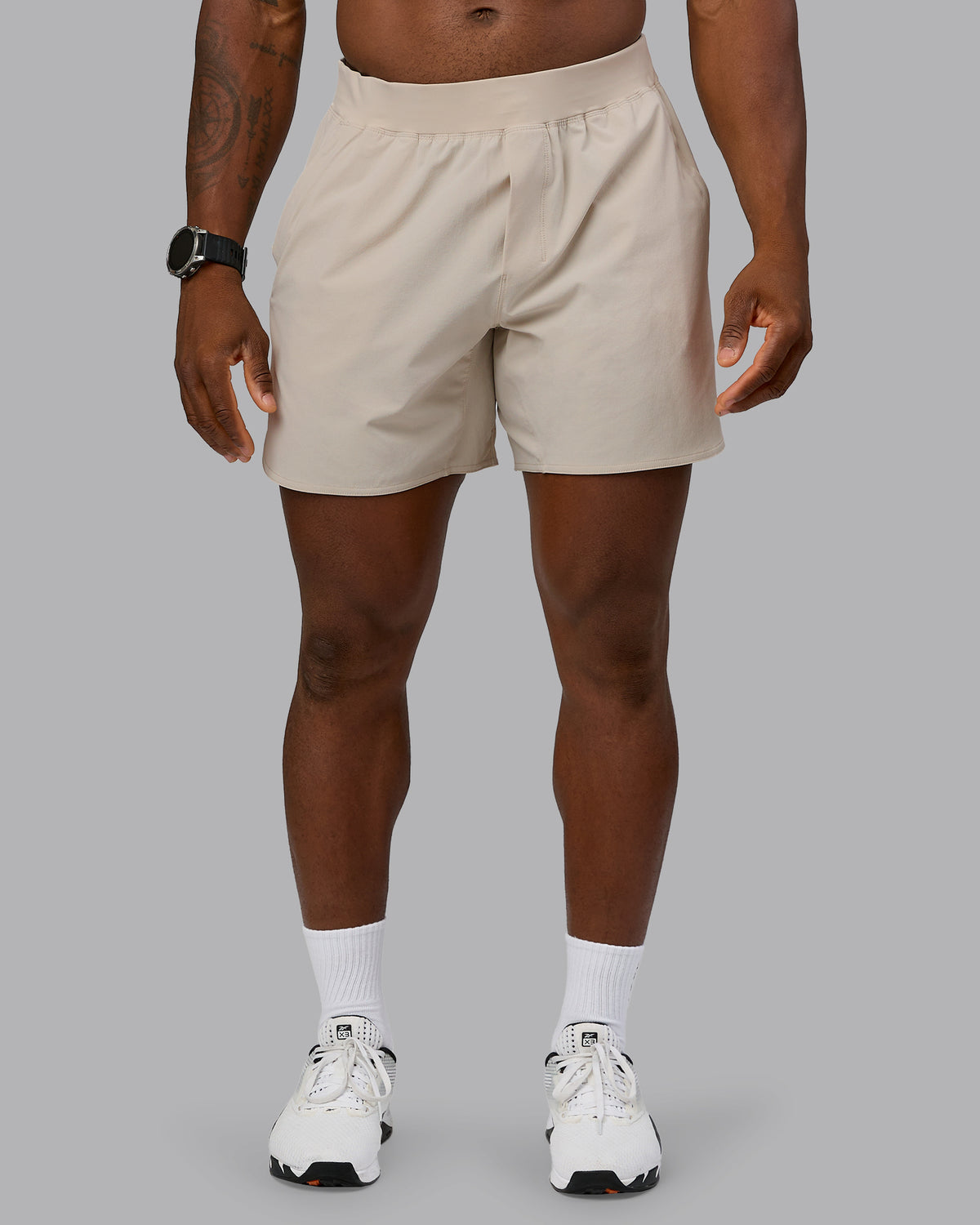 Man wearing Lift 6" Performance Short - Shale-Beige | Model:Sam | Size:L