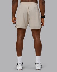 Man wearing Lift 6" Performance Short - Shale-Beige | Model:Sam | Size:L | Thumbnail Index: 3