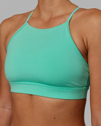 Woman wearing Lift High Neck Sports Bra - Cockatoo | Thumbnail Index: 3