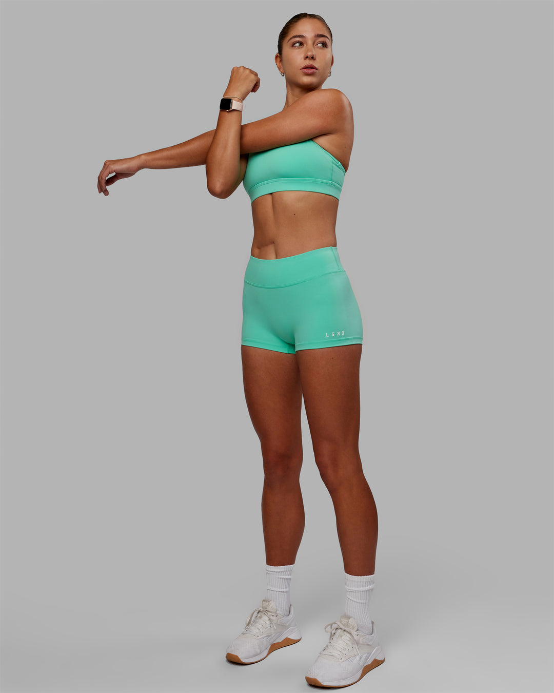 Woman wearing Lift High Neck Sports Bra - Cockatoo - view 8