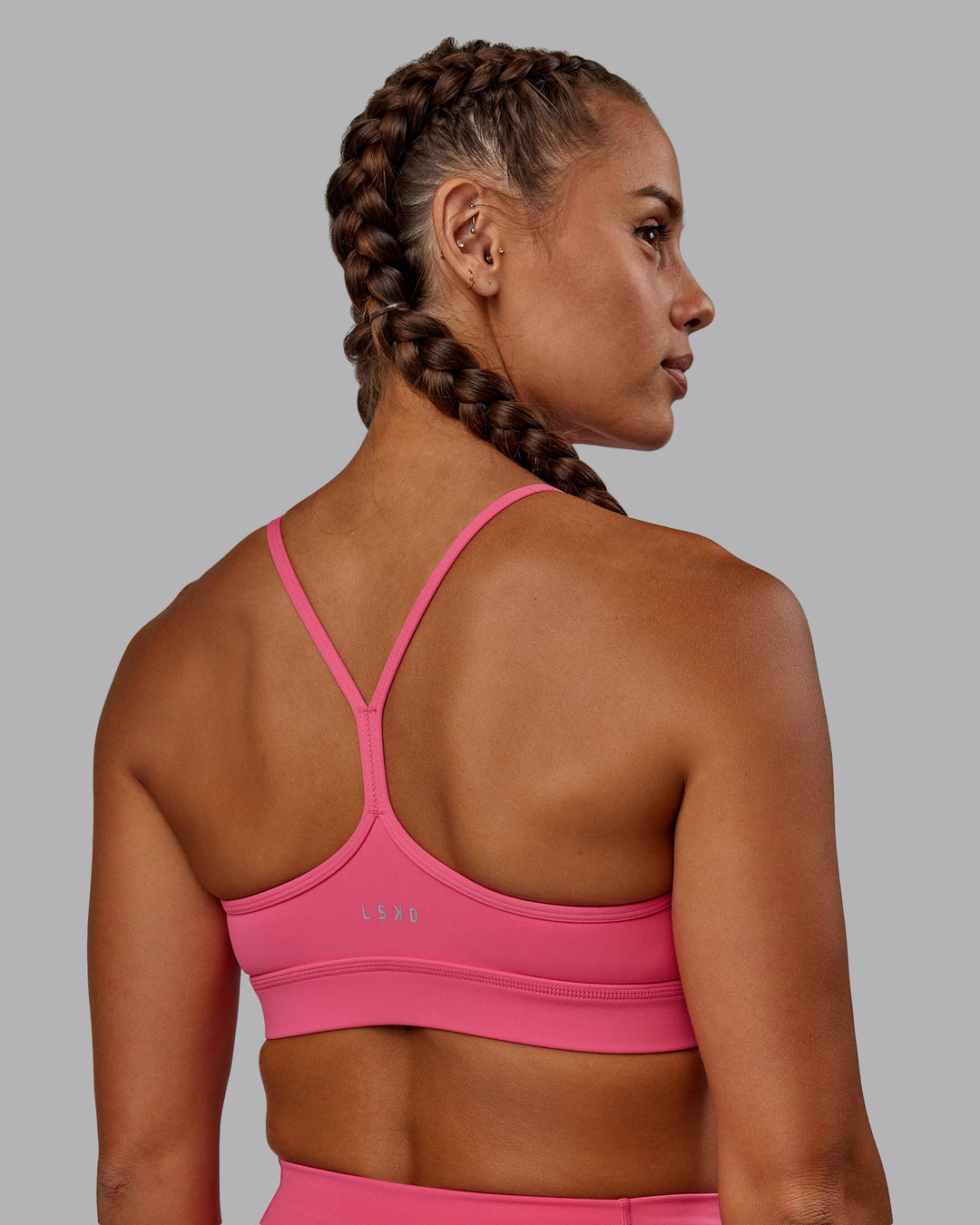Woman wearing Lift High Neck Sports Bra - Hot Pink - view 2