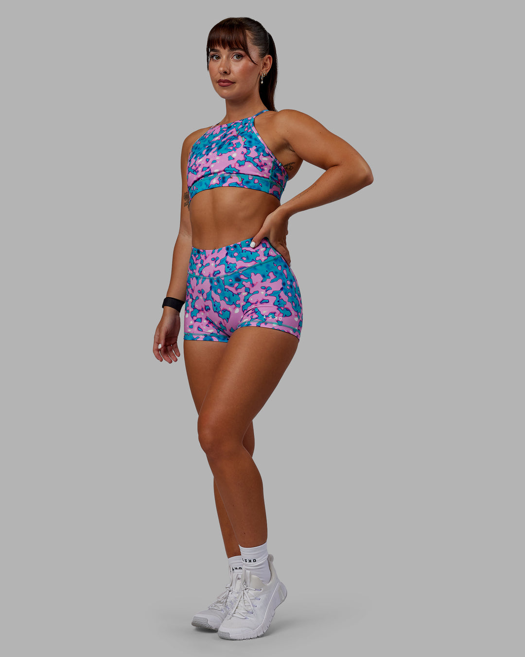 Woman wearing Lift High Neck Sports Bra - Neon Camo - view 3